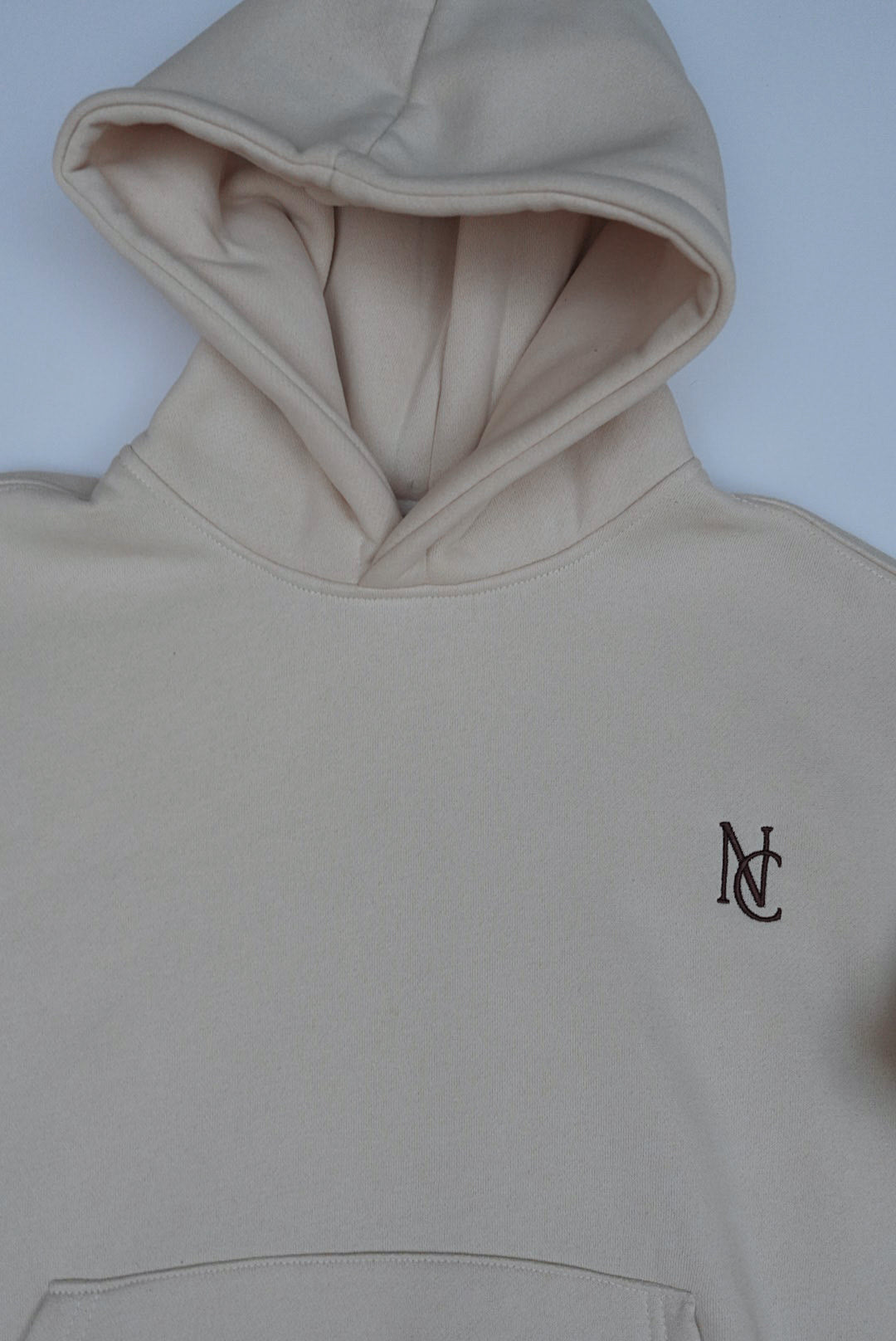 Woman's Mini & Me - Beige Butter Soft Trackies: Light-beige pullover hoodie with kangaroo pocket, hood, and NC logo, designed oversized and buttery soft for all-season twinning.