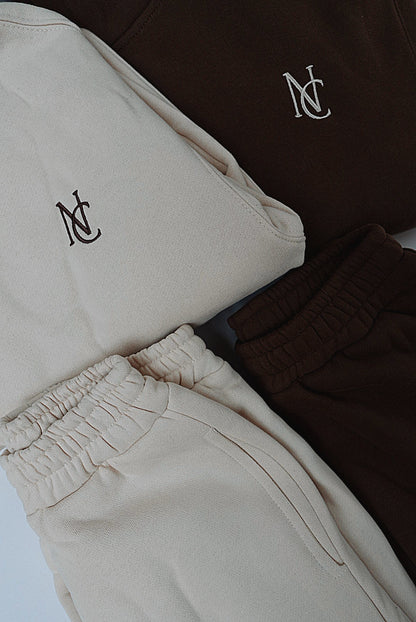 Kid's Mini & Me's - Butter Soft Hoodie features a cozy, oversized design with an NC logo, paired with matching jogger sweatpants for twinning comfort.