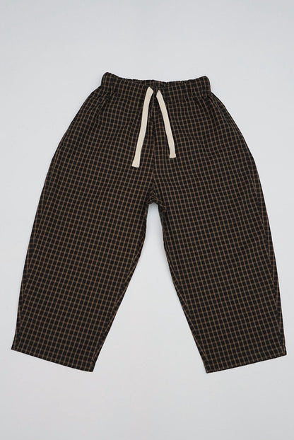 Brown Gingham Trousers with relaxed fit, ankle-length design, elastic waistband, and off-white drawstring, featuring a small grid pattern ideal for casual wear.