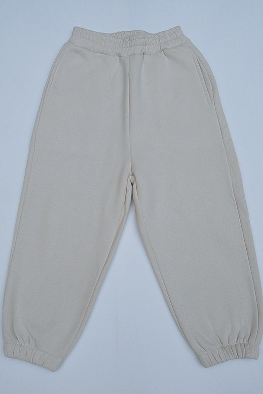 Woman's Mini & Me - Beige Butter Soft Trackies feature plain, light-beige joggers with elastic waistband, side pockets, and ankle cuffs, offering oversized, buttery softness.