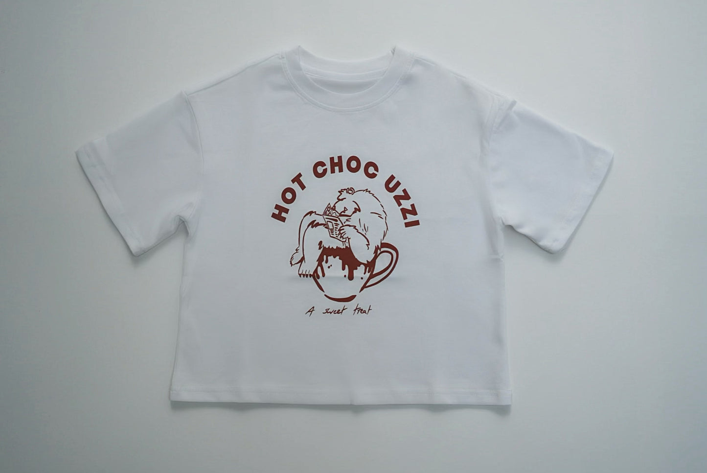 HOT CHOC UZZI TEE with cartoon bear in a mug graphic, perfect for winter. Made from 100% cotton, ideal for your child's cozy wardrobe.