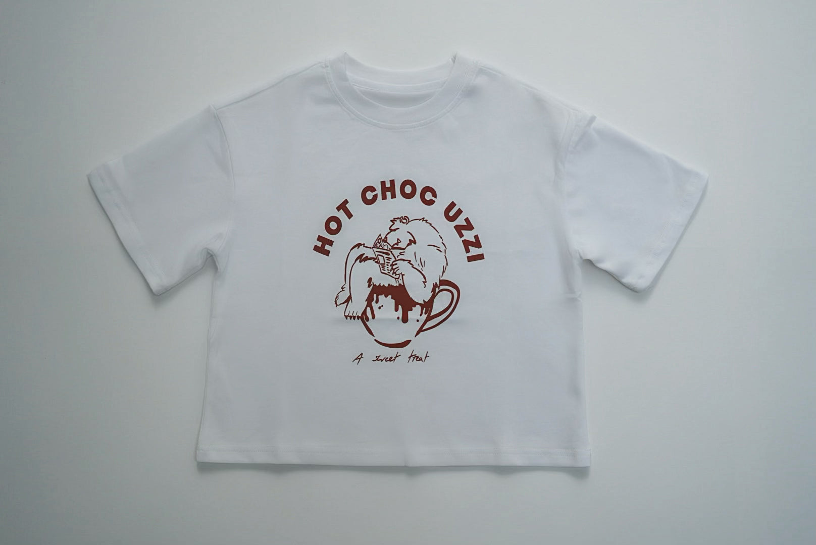 HOT CHOC UZZI TEE with cartoon bear in a mug graphic, perfect for winter. Made from 100% cotton, ideal for your child's cozy wardrobe.