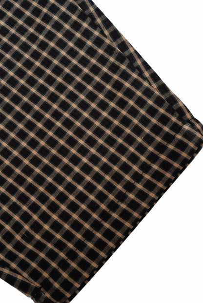 Close-up of Brown Gingham Trousers fabric, showcasing the black-and-tan plaid pattern, indicative of the trousers' comfortable, relaxed fit with drawstring waistband.